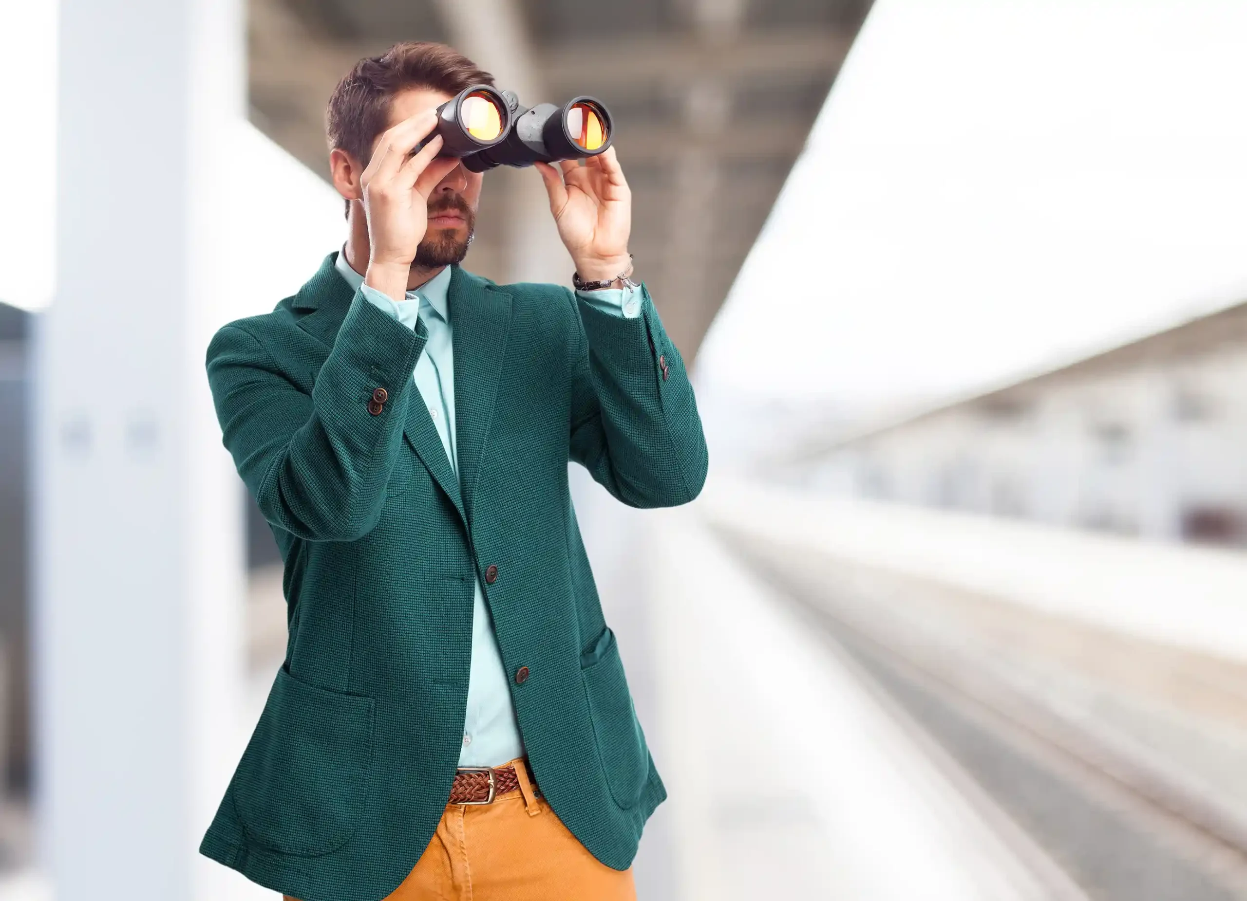 man with green suit with binoculars